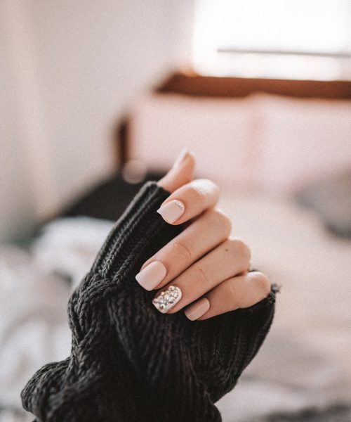 person in black long sleeve shirt holding black textile
